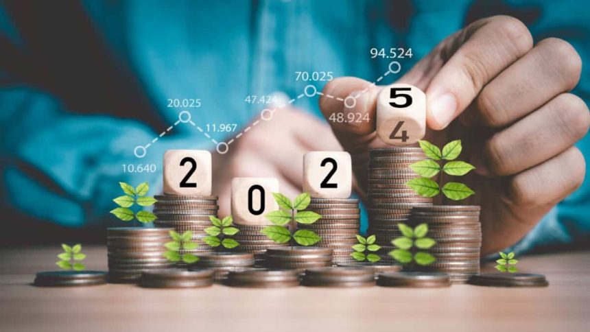 Businessman hand flipping wooden block cube from 2024 to 2025 on coins