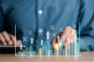 Businessman hand stacking money coins with virtual percentage icons