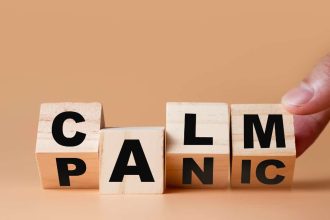 Hand flipping wooden cubes for change wording" Panic" to " Calm".