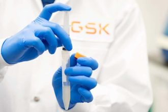 GSK scientist holding lab syringe