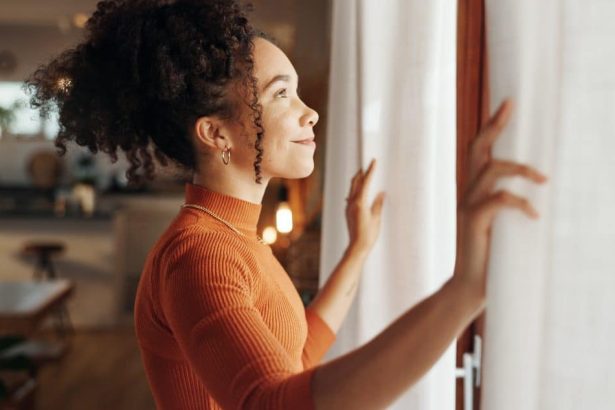 Curtains, happy woman and thinking of future in home, planning and reflection of mindset with view. Window, smile and African girl with vision, ideas and dream for morning inspiration in living room.